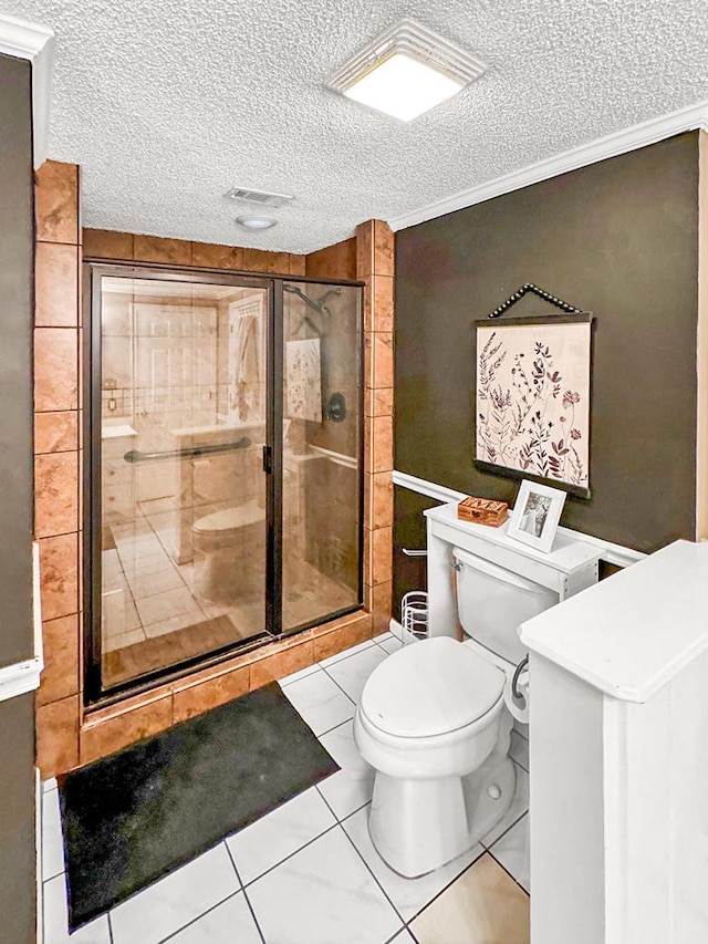 bathroom with toilet, a stall shower, ornamental molding, and a textured ceiling