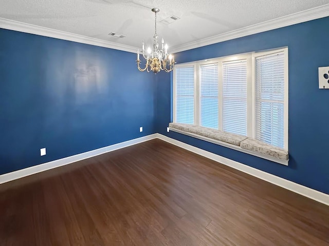 empty room with wood finished floors, visible vents, baseboards, an inviting chandelier, and crown molding