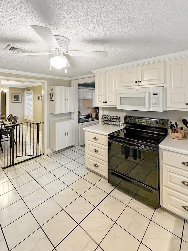 102 Bremond St, Colquitt, GA 39837 - kitchen featuring white microwave, black electric range oven, light countertops, a textured ceiling, and ceiling fan