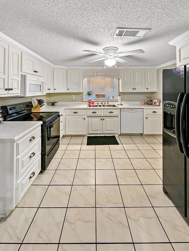 kitchen with visible vents, a sink, black appliances, light countertops, and white cabinetry