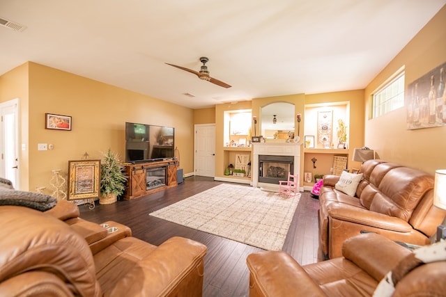 168 Douglas Pointe Dr, Bainbridge, GA 39819 - living area with a fireplace, ceiling fan, and dark wood-style flooring