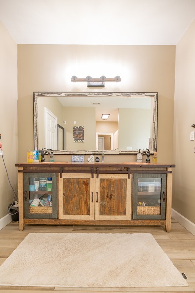 bathroom with vanity and wood-type flooring