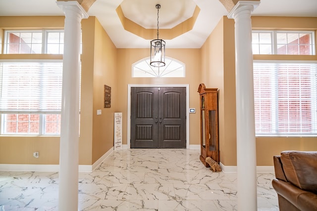 entrance foyer featuring a healthy amount of sunlight and ornate columns