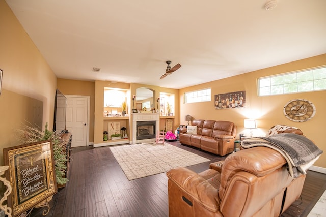 living room featuring dark hardwood / wood-style floors and ceiling fan