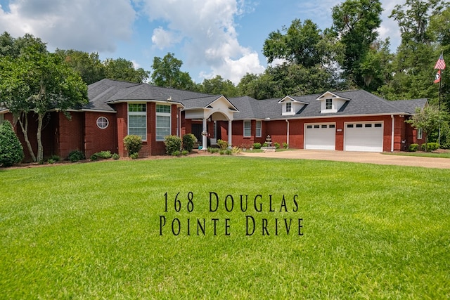 ranch-style home featuring a garage and a front lawn