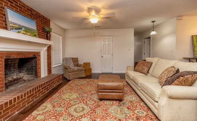 living room with ceiling fan, dark hardwood / wood-style flooring, and a fireplace