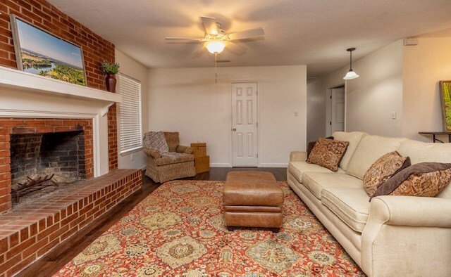 401 Simms St, Bainbridge, GA 39819 - living area featuring a ceiling fan, wood finished floors, and a fireplace