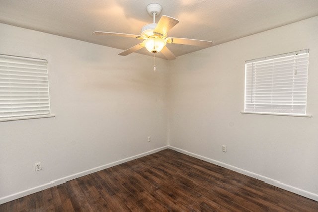 unfurnished room with ceiling fan and dark hardwood / wood-style floors