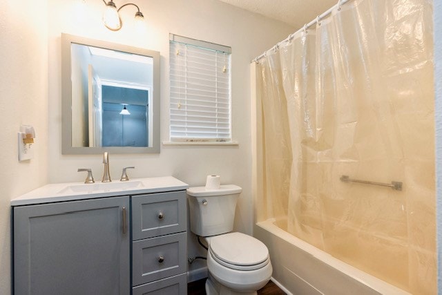 full bathroom featuring toilet, vanity, and shower / tub combo with curtain