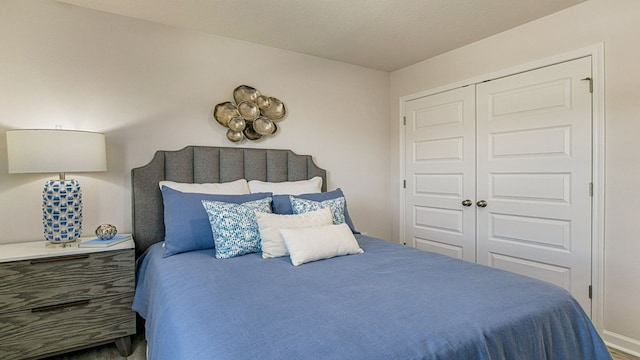 bedroom with a textured ceiling and a closet