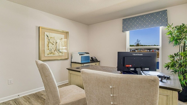 office area with hardwood / wood-style floors and a textured ceiling