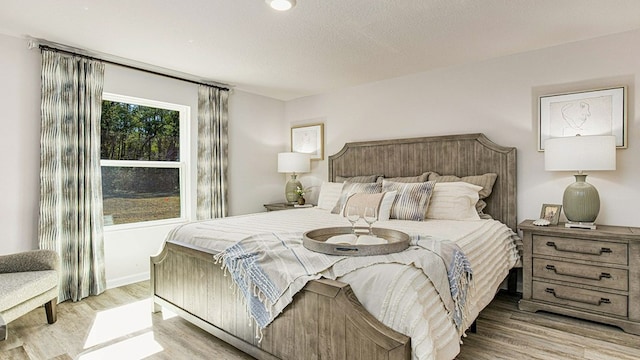 bedroom with light hardwood / wood-style floors