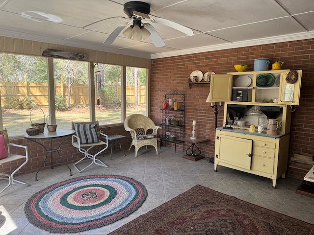 sunroom featuring a ceiling fan