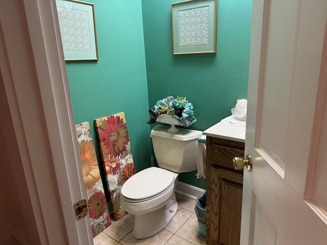 bathroom with toilet, vanity, and tile patterned floors