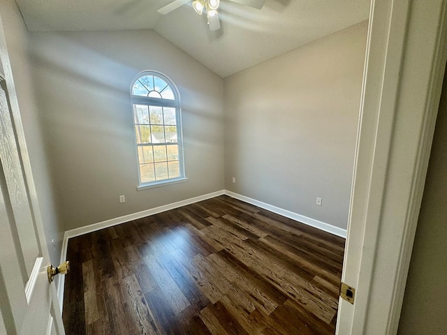 unfurnished room with vaulted ceiling, dark hardwood / wood-style floors, and ceiling fan