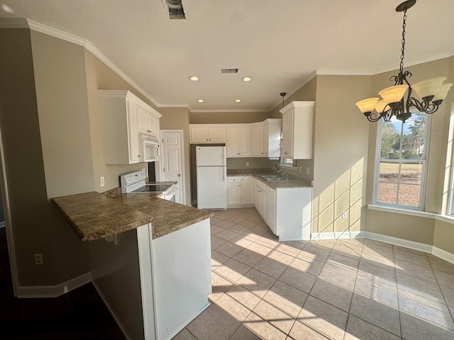 kitchen with pendant lighting, white cabinets, a chandelier, kitchen peninsula, and white appliances