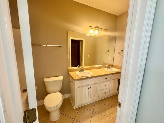 bathroom featuring vanity, tile patterned floors, and toilet