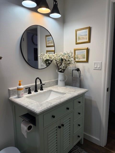 bathroom with vanity and hardwood / wood-style flooring