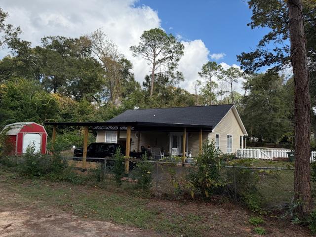 back of house featuring a carport