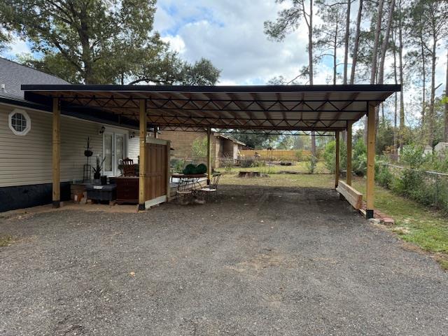 view of parking / parking lot featuring a carport