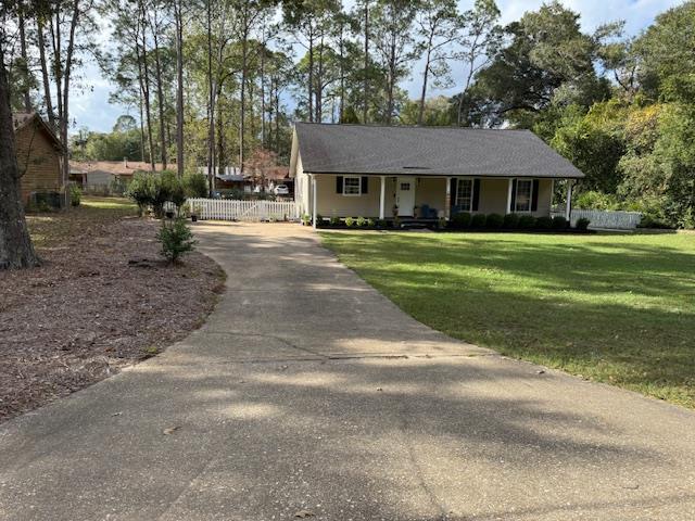 single story home featuring a porch and a front yard