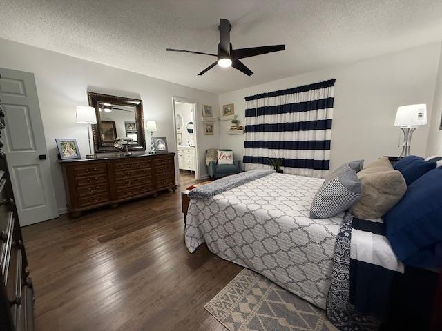 bedroom with dark hardwood / wood-style flooring, a textured ceiling, and ceiling fan