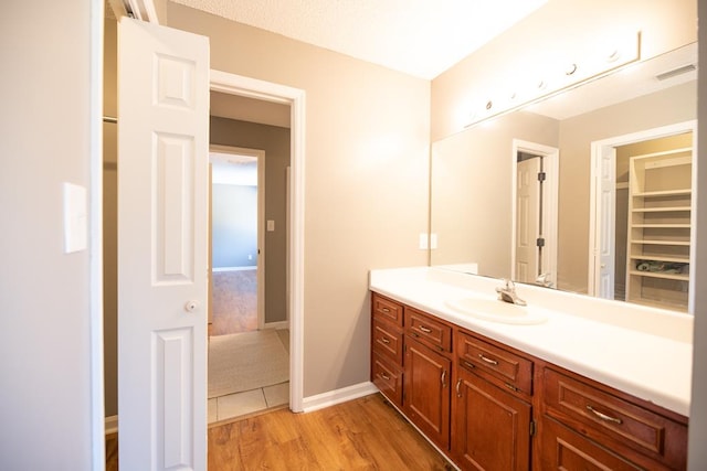 bathroom with hardwood / wood-style floors and vanity