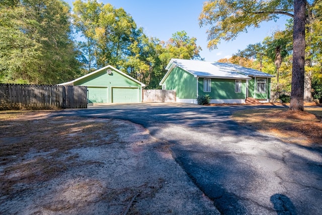 exterior space with a garage and an outdoor structure