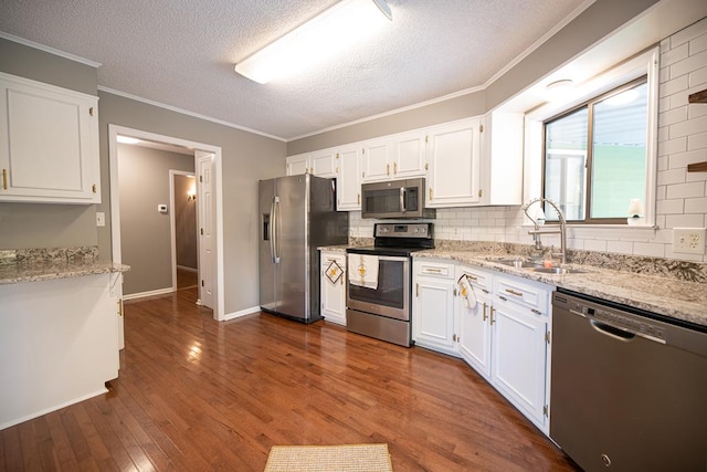 kitchen featuring sink, white cabinets, dark wood-type flooring, and appliances with stainless steel finishes