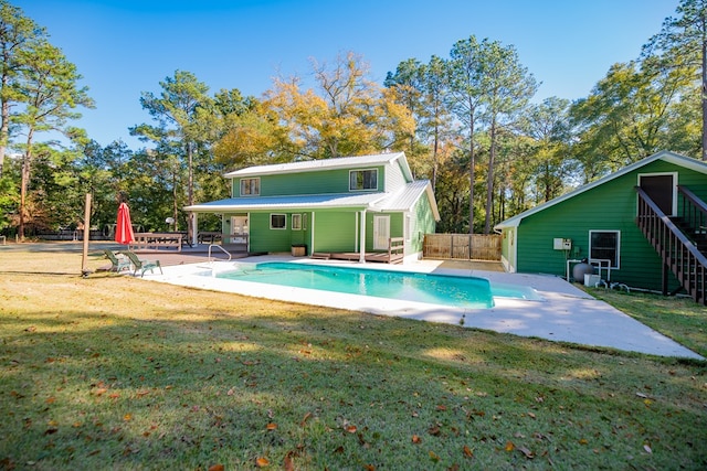 view of swimming pool with a lawn and a patio area