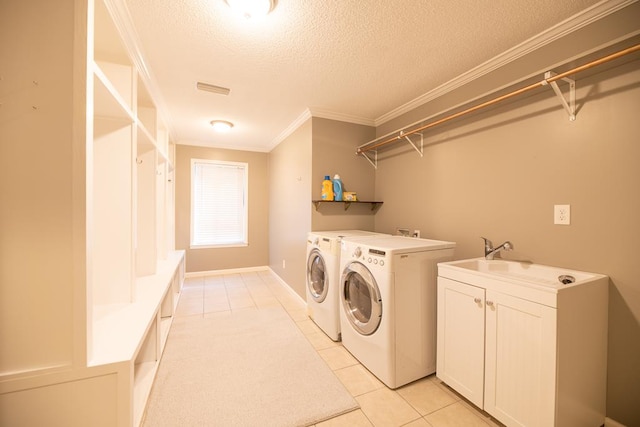 washroom featuring sink, light tile patterned floors, a textured ceiling, and ornamental molding