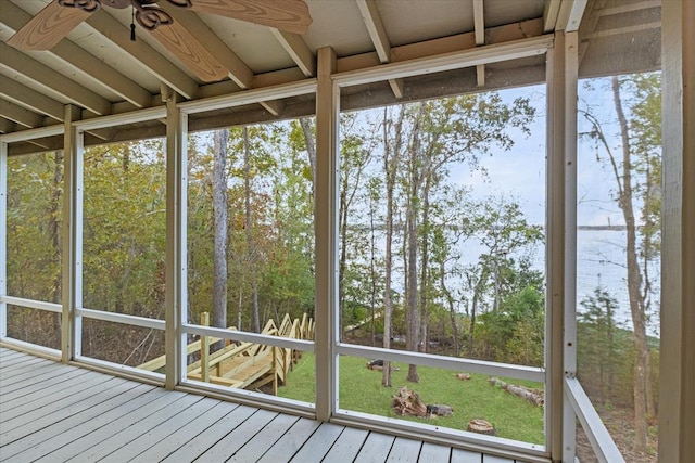 unfurnished sunroom featuring ceiling fan and plenty of natural light