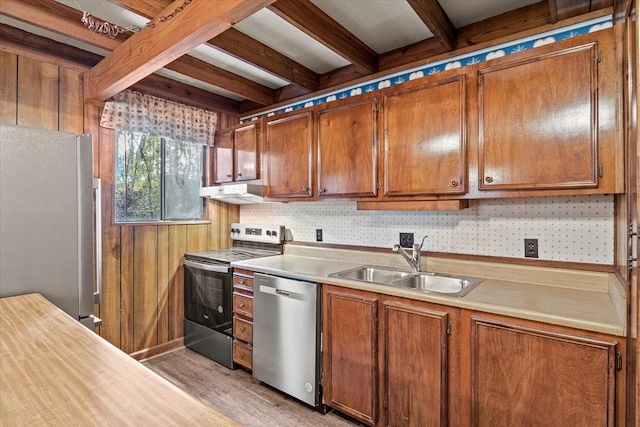 kitchen featuring stainless steel appliances, sink, light wood-type flooring, wood walls, and beam ceiling