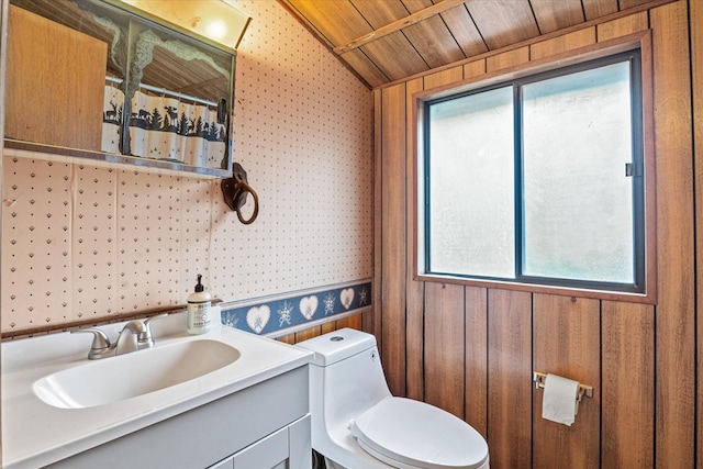 bathroom featuring toilet, a healthy amount of sunlight, wooden walls, and wooden ceiling