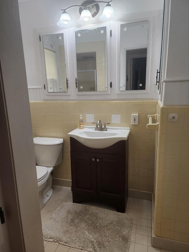 358/356 Hull St, Colquitt, GA 39837 - bathroom featuring vanity, tile patterned flooring, tile walls, and a wainscoted wall