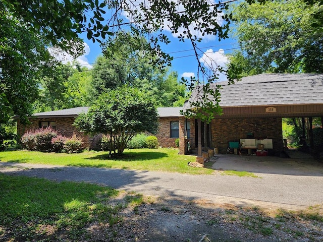 358/356 Hull St, Colquitt, GA 39837 - view of front of property featuring a shingled roof, a front lawn, brick siding, and a carport