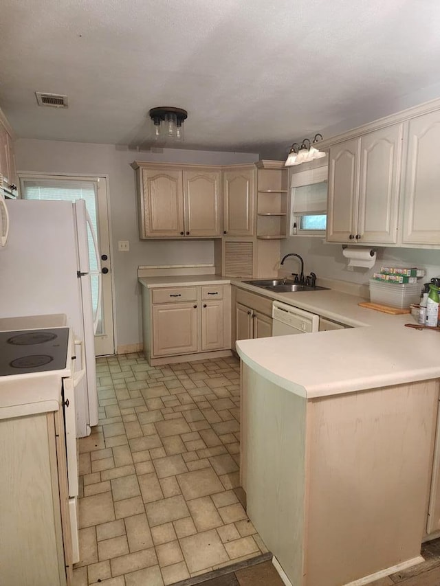 358/356 Hull St, Colquitt, GA 39837 - kitchen featuring brick patterned flooring, a peninsula, white appliances, light countertops, and open shelves