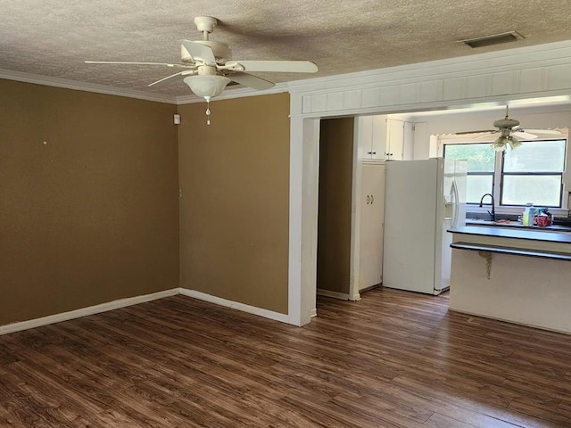 358/356 Hull St, Colquitt, GA 39837 - empty room with a ceiling fan, ornamental molding, dark wood-style flooring, and a textured ceiling