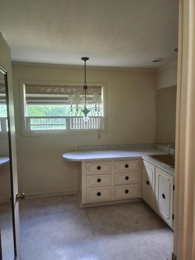 358/356 Hull St, Colquitt, GA 39837 - kitchen featuring a chandelier, white cabinets, ornamental molding, hanging light fixtures, and light countertops
