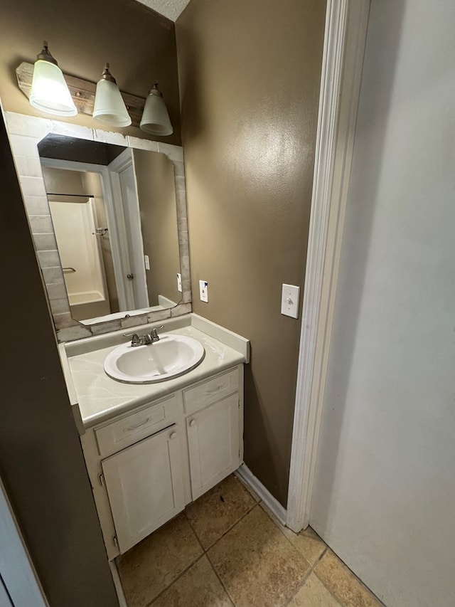 bathroom featuring a textured ceiling and vanity