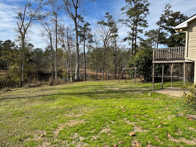 view of yard with a deck and a playground