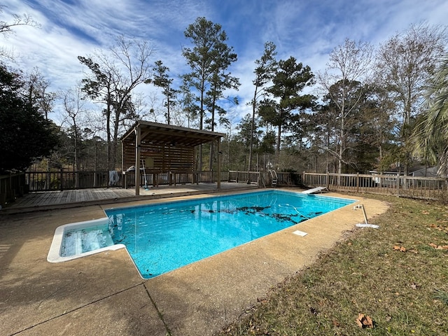 view of swimming pool featuring a diving board and a deck