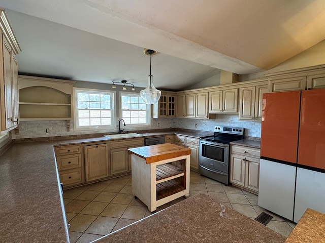 kitchen featuring lofted ceiling, electric range, butcher block countertops, fridge, and sink