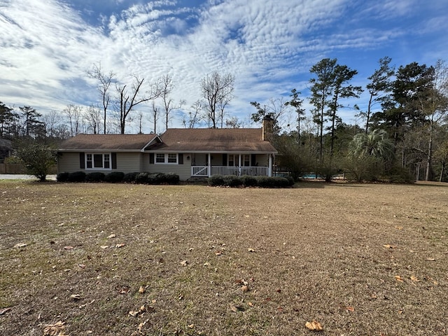 single story home with a porch and a front yard