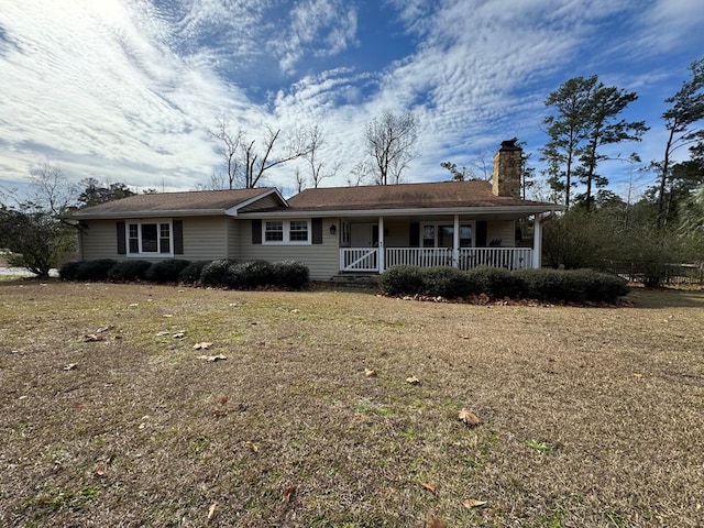 ranch-style house featuring a porch and a front lawn