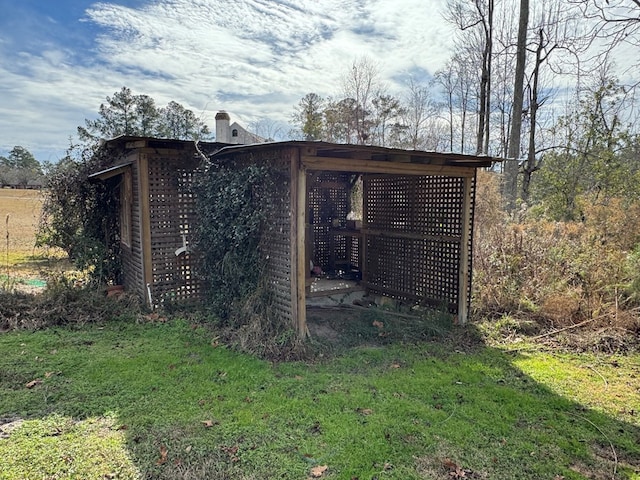 view of outbuilding featuring a lawn