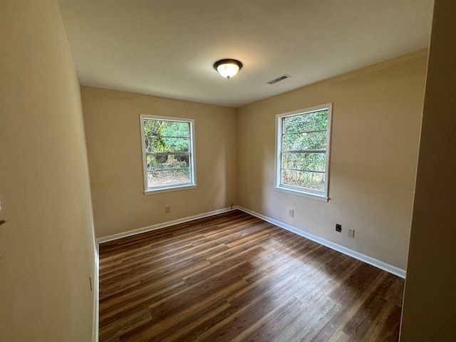 spare room with dark hardwood / wood-style flooring