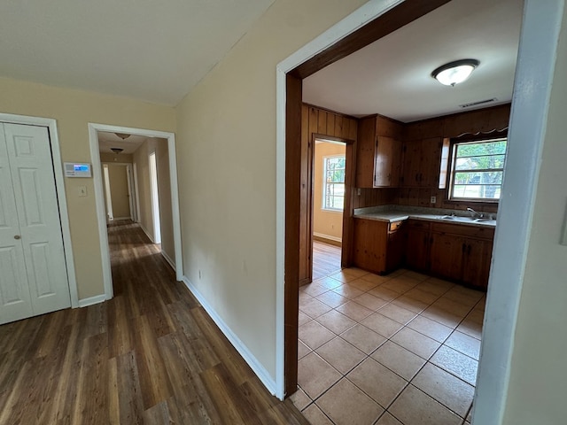 kitchen featuring light wood-type flooring, backsplash, and sink