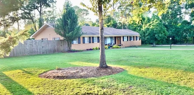 ranch-style home with a front lawn