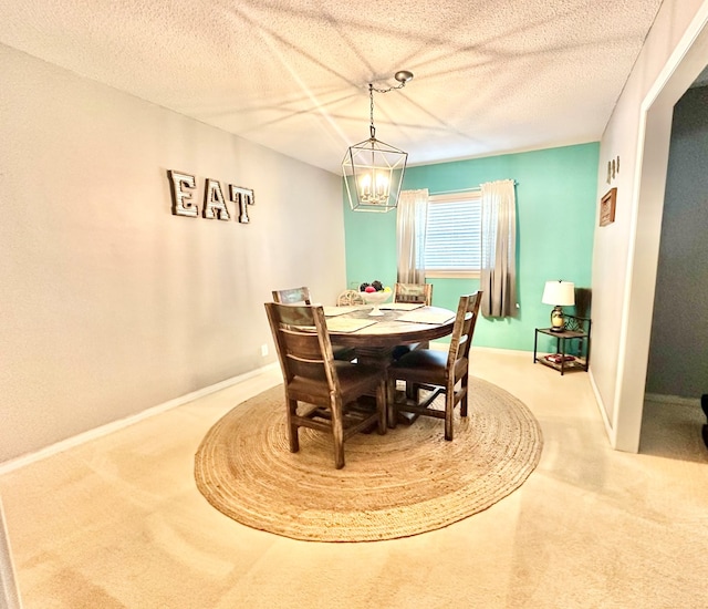 dining area featuring carpet floors and a textured ceiling